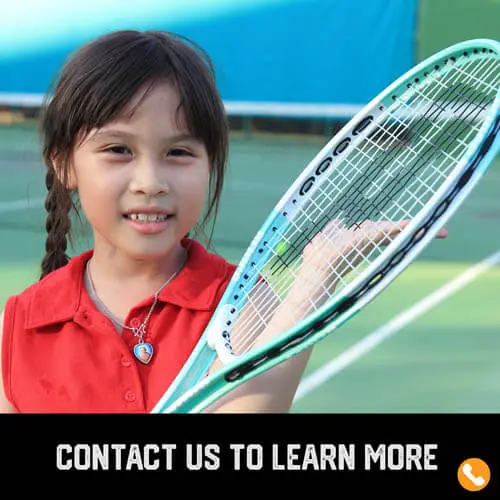 Youth sports girl tennis player holding her racket on a tennis court