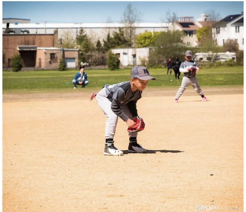 Youth sports baseball player ready to field ball on baseball field for Newfield Little League in East Bridgeport Connecticut with the All Kids Play financial assistance grant
