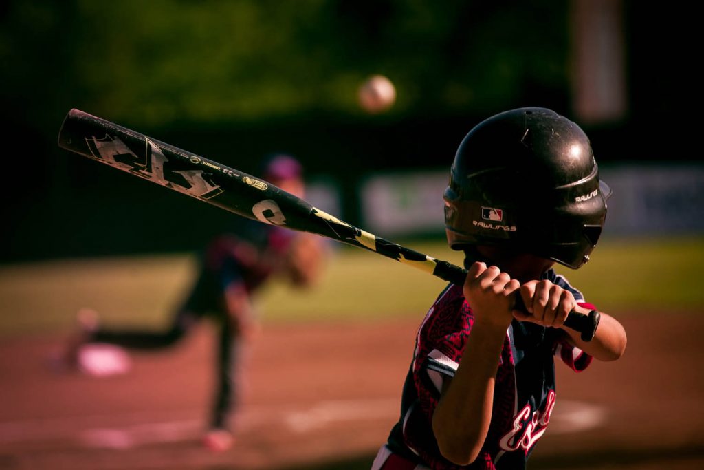 Youth sports boy baseball player at bat ready to hit a baseball during a game